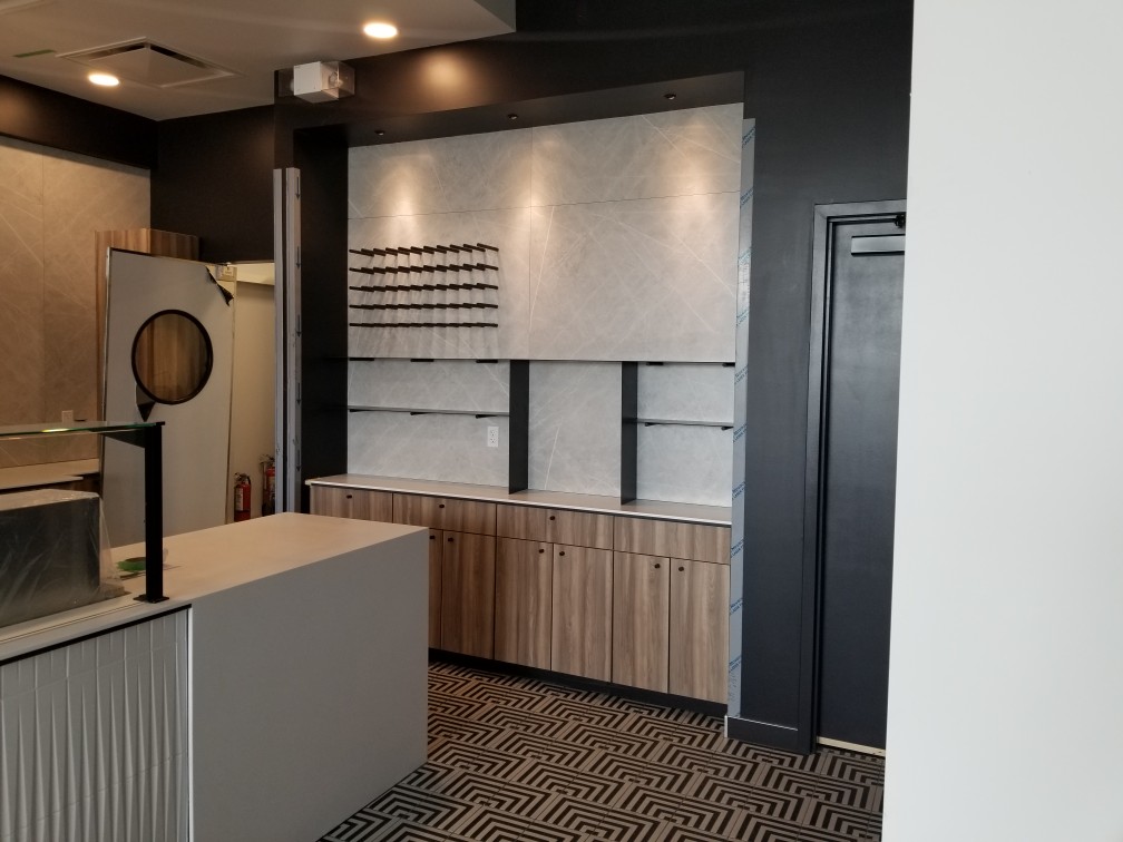 Contemporary showroom-style cabinetry with wood-textured finishes and integrated lighting